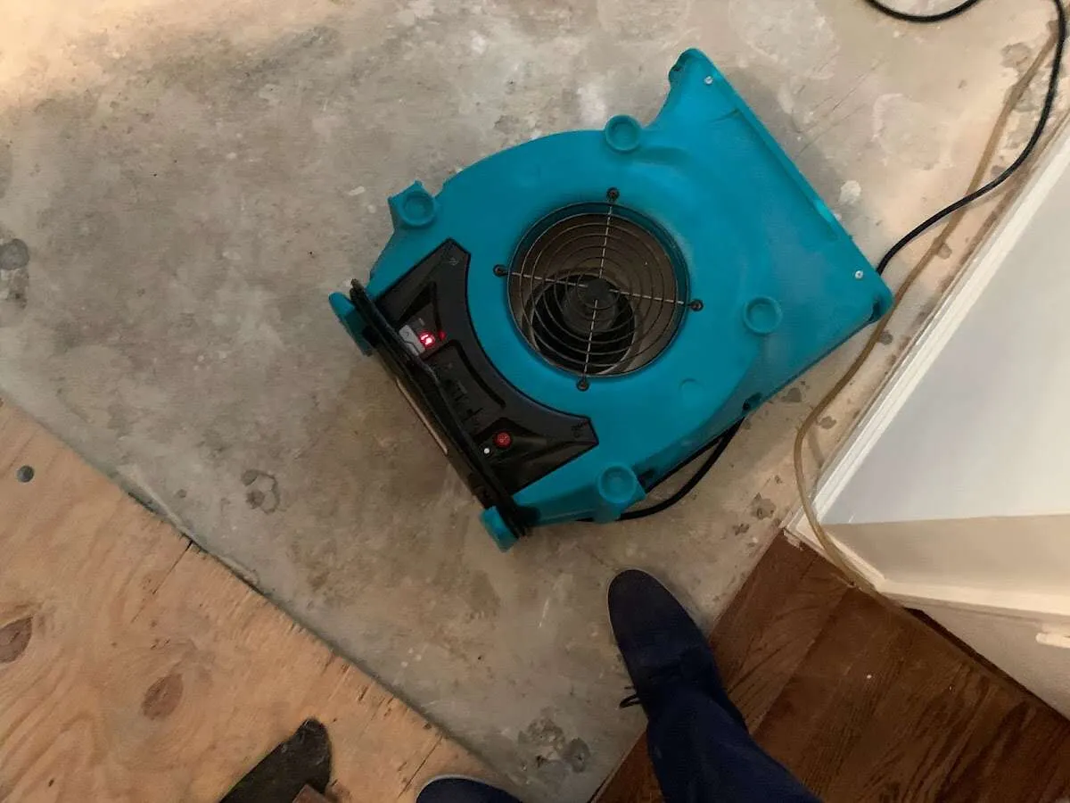 Air mover drying subfloor during Commercial Water Damage Restoration in Wood Dale
